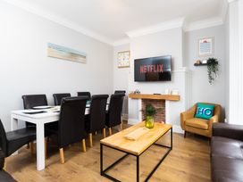A dining room with a table and chairs, television and sofa at 38 Ashville Avenue in Scarborough