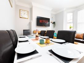 A dining room with a table set for meals at 38 Ashville Avenue in Scarborough