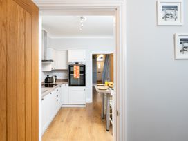A kitchen with an oven and table at 38 Ashville Avenue in Scarborough