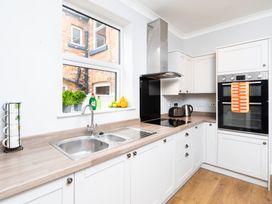 A kitchen with a sink, kettle, oven, and herbs at 38 Ashville Avenue Scarborough