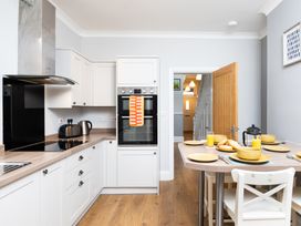 A kitchen with a table set for breakfast at 38 Ashville Avenue in Scarborough