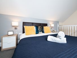 A bedroom with a bed and nightstand at 38 Ashville Avenue Scarborough
