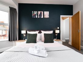 A bedroom with a bed and artwork at 38 Ashville Avenue Scarborough