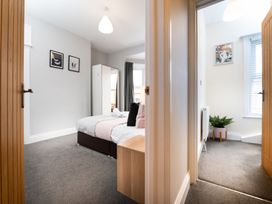 A bedroom with a bed and wardrobe at 38 Ashville Avenue in Scarborough