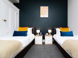 A bedroom with two single beds and nightstands at 38 Ashville Avenue Scarborough