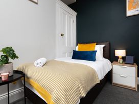 A bedroom with a bed and bedside table at 38 Ashville Avenue in Scarborough