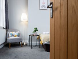 A bedroom with a bed and chair at 38 Ashville Avenue Scarborough