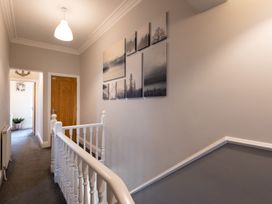 A hallway with pictures on the wall and a staircase at 38 Ashville Avenue, Scarborough