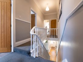 A hallway with stairs leading to doors at 38 Ashville Avenue Scarborough