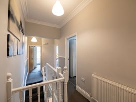 A hallway with stairs and doors at 38 Ashville Avenue Scarborough