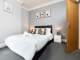 A bedroom with a bed and bedside table at 38 Ashville Avenue, Scarborough