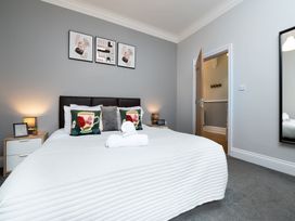A bedroom with a bed and bedside tables at 38 Ashville Avenue Scarborough