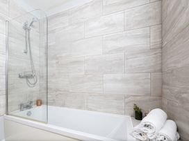 A bathroom featuring a bathtub and shower at 38 Ashville Avenue, Scarborough