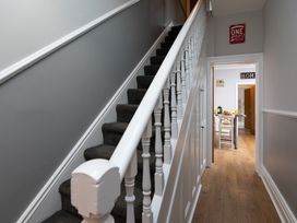 A hallway with a staircase leading up and a table in the background at 38 Ashville Avenue, Scarborough