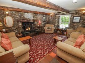 A living room with a sofa, fireplace, and coffee table at Ty Mawr Country House, Carmarthen
