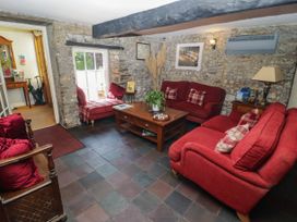 A living room with red sofas and a coffee table at Ty Mawr Country House in Carmarthen