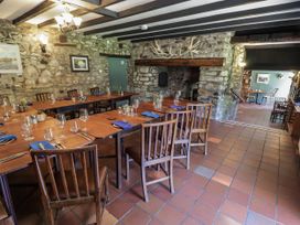 A dining room with tables and chairs at Ty Mawr Country House in Carmarthen