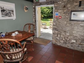 A dining room with a table and chairs at Ty Mawr Country House in Carmarthen