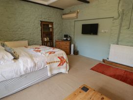 A bedroom with a bed and shelf at Ty Mawr Country House in Carmarthen