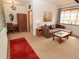 A living room with a sofa and table at Ty Mawr Country House in Carmarthen