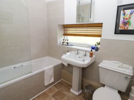 A bathroom with bathtub, sink, and toilet at Ty Mawr Country House in Carmarthen
