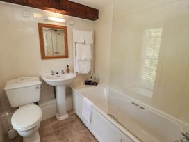 A bathroom with a bathtub, sink and toilet at Ty Mawr Country House in Carmarthen