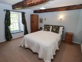 A bedroom with a bed and window at Ty Mawr Country House in Carmarthen
