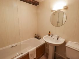 A bathroom with a bathtub, sink, and toilet at Ty Mawr Country House in Carmarthen