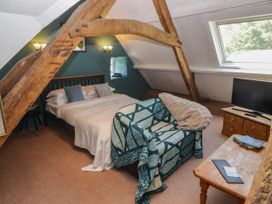A bedroom with a bed and sofa at Ty Mawr Country House in Carmarthen
