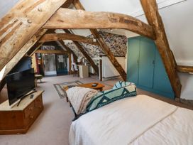A bedroom with a bed and television at Ty Mawr Country House, Carmarthen