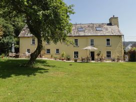 A house with a garden and patio at Ty Mawr Country House in Carmarthen