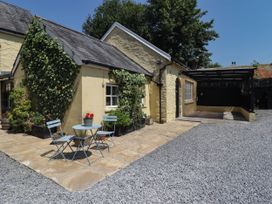 An outdoor space with a table and chairs at Ty Mawr Country House in Carmarthen