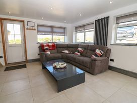 A living room with a sofa and coffee table at Cefnbron in Caernarfon