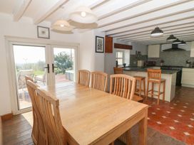 A dining room with wooden table and chairs at Cefnbron in Caernarfon