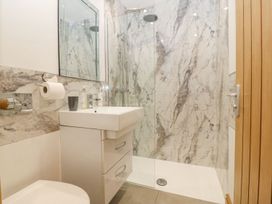 A bathroom with a shower and sink at Cefnbron Caernarfon