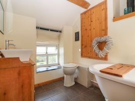 A bathroom with a sink, toilet, and bathtub at Cefnbron, Caernarfon