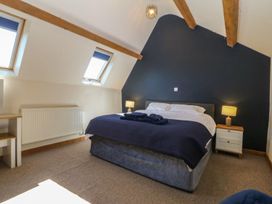 A bedroom with a bed and bedside table at Cefnbron in Caernarfon
