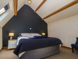 A bedroom with a bed and nightstand at Cefnbron in Caernarfon