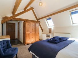A bedroom with a bed and wardrobe at Cefnbron in Caernarfon
