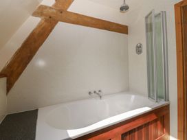A bathroom with a bathtub and shower at Cefnbron in Caernarfon
