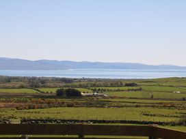 A view of water and mountains from a distance at Cefnbron in Caernarfon