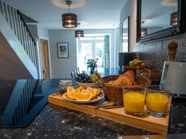 A kitchen with fruit and drinks on the counter at Gwynfryn House in Llanbedr