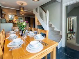 A dining room with a table set for a meal at Gwynfryn House in Llanbedr
