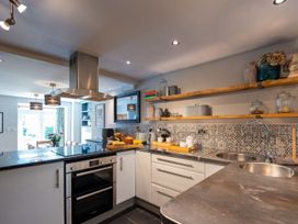 A kitchen with modern appliances and a dining area at Gwynfryn House Llanbedr