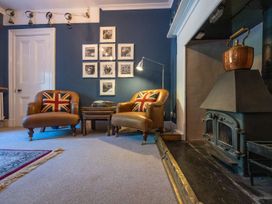 A living room with armchairs and a fireplace at Gwynfryn House in Llanbedr