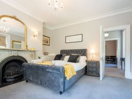 A bedroom with a bed and dresser at Gwynfryn House in Llanbedr