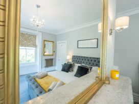 A bedroom with a bed and window at Gwynfryn House in Llanbedr