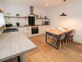A kitchen with a dining table and chairs at Canny Cottage in Belford