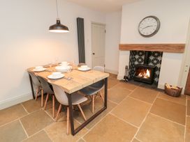 A dining room with a table and chairs at Canny Cottage in Belford