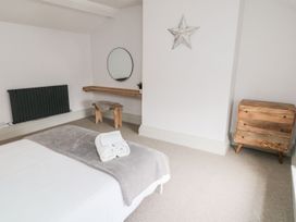 A bedroom with a bed and wooden furniture at Canny Cottage in Belford